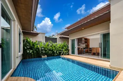 a swimming pool in the backyard of a villa at Prima Karon Villa in Karon Beach