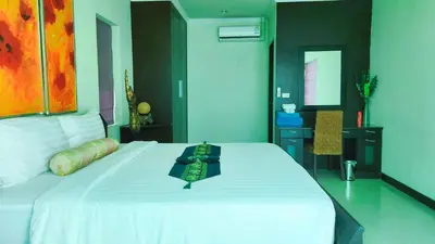 a bedroom with a white bed with a tray on it at Prima Karon Villa in Karon Beach