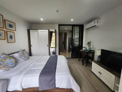 a bedroom with a large bed and a television at The Base Central Phuket-C54BS in Phuket Town