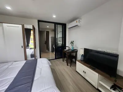 a bedroom with a bed and a flat screen tv at The Base Central Phuket-C54BS in Phuket Town