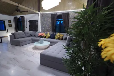 a living room with a couch and a table at Villa Omloft in Changwat Phuket