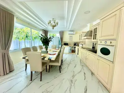 a kitchen with a table and chairs and a dining room at Dolce Vita Villa Memory Bang-Tao Phuket in Ban Thalat Choeng Thale