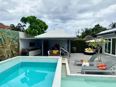 a swimming pool next to a patio with a house at Dolce Vita Villa Memory Bang-Tao Phuket in Ban Thalat Choeng Thale