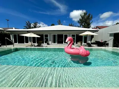 a swimming pool with a inflatable flamingo in the water at Dolce Vita Villa Memory Bang-Tao Phuket in Ban Thalat Choeng Thale