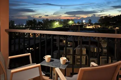 a balcony with a table with two cups on it at Seaview 1bdr apartment Karon PRO-613 in Karon Beach