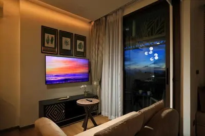 a living room with a couch and a large window at Seaview 1bdr apartment Karon PRO-613 in Karon Beach