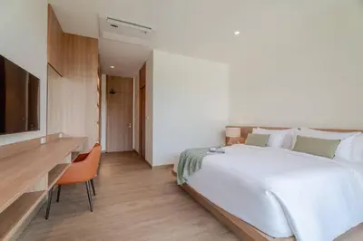 a bedroom with a large white bed and a desk at Liva Villa near Rawai Phuket in Ban Saiyuan (1)