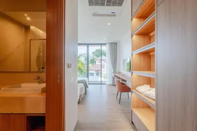 a bathroom with a sink and a bed in a room at Liva Villa near Rawai Phuket in Ban Saiyuan (1)