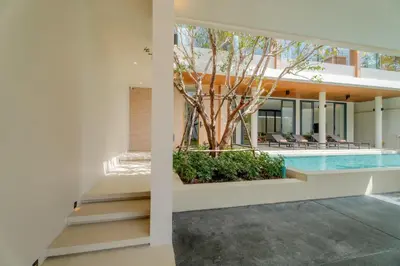 a house with a swimming pool and a tree at Liva Villa near Rawai Phuket in Ban Saiyuan (1)
