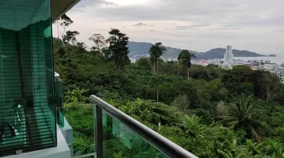 a balcony of a house with a view of a city at Thebirdhouse Patong Phuket 302 in Patong Beach