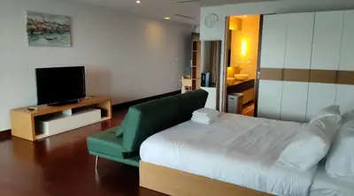 a hotel room with a bed and a television at Thebirdhouse Patong Phuket 302 in Patong Beach