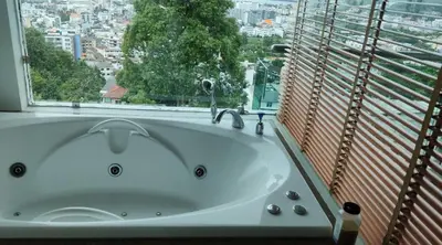 a bath tub in a bathroom with a window at Thebirdhouse Patong Phuket 302 in Patong Beach