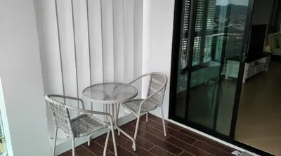 a table and two chairs on a balcony at Thebirdhouse Patong Phuket 302 in Patong Beach