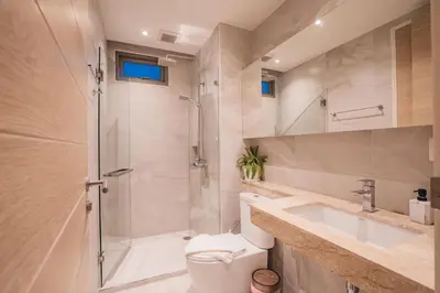 a bathroom with a shower and a toilet and a sink at The Paradise sea view apartment in Krabi town