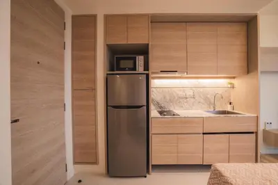 a kitchen with a stainless steel refrigerator and a microwave at The Paradise sea view apartment in Krabi town