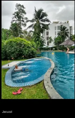 a swimming pool with a person in the water at casuarina shores penthouse in Bang Tao Beach