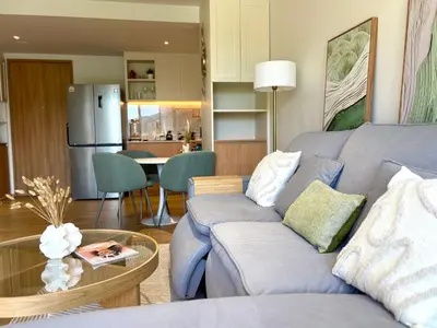 a living room with a couch and a table at Laguna BeachSide 200m to beach BangTao in Bang Tao Beach