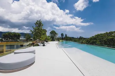 a large swimming pool with white chairs and a swimming pool at Laguna BeachSide 200m to beach BangTao in Bang Tao Beach