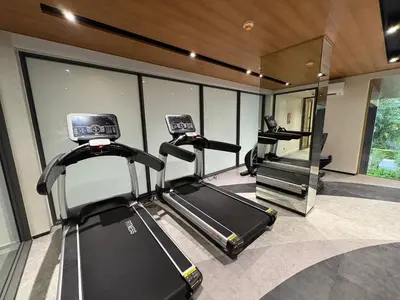 a gym with two exercise bikes and a mirror at Laguna BeachSide 200m to beach BangTao in Bang Tao Beach