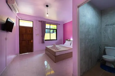 a room with a bed and a shower and a toilet at myPatong Social Hostel in Patong Beach