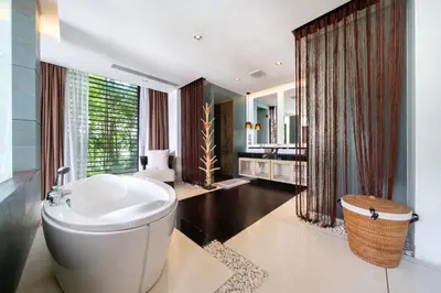 a bathroom with a large white tub in a room at Exclusive Oceanfront Living, 5BR Pool Villa Elegance in Ko Lek