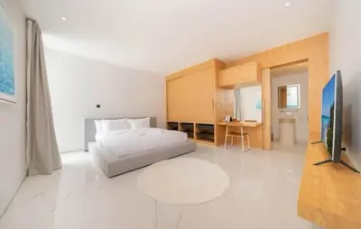 a bedroom with a bed and a flat screen tv at Ola-Villa in Kamala Beach