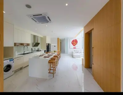 a large kitchen with a counter and chairs in it at Ola-Villa in Kamala Beach