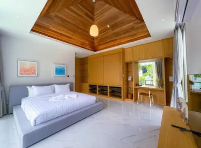a bedroom with a bed and a wooden ceiling at Ola-Villa in Kamala Beach