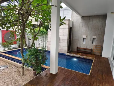 a swimming pool in a building with trees in it at Oxygen Villa 3 beds in Rawai Beach
