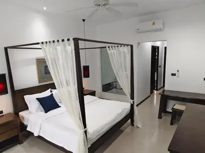 a bedroom with a canopy bed and a piano at Oxygen Villa 3 beds in Rawai Beach
