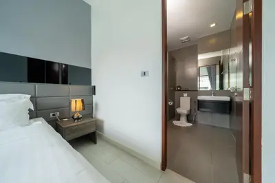 a bedroom with a bed and a bathroom with a sink at Private Pool View 1BR Apartment in Naiharn Residence near Beach, UTN D502 in Rawai Beach