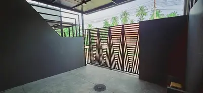 an empty room with a large window with palm trees at Cactus Villa 2024, Krabi in Klong Muang Beach