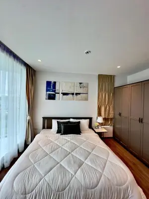 a bedroom with a large white bed with a window at 2BR 4Beds Luxury Condo Pool & Fitness in Phuket Town