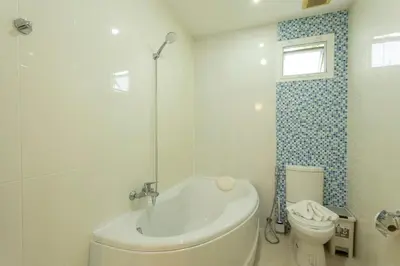 a bathroom with a tub and a toilet and a sink at V129 Walking To Award winning Naiharn Beach 4BR in Rawai Beach