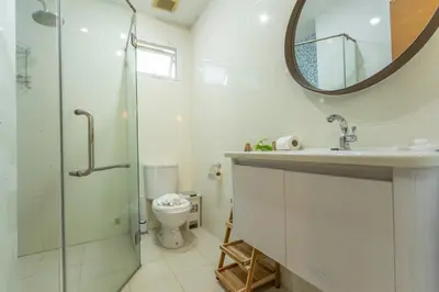 a bathroom with a shower and a toilet and a mirror at V129 Walking To Award winning Naiharn Beach 4BR in Rawai Beach