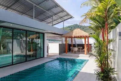 a house with a swimming pool in front of a house at V68 Paradise Found 2BR Villa Bliss in rawai in Kata Beach