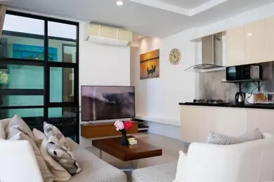 a living room with a white couch and a kitchen at V68 Paradise Found 2BR Villa Bliss in rawai in Kata Beach