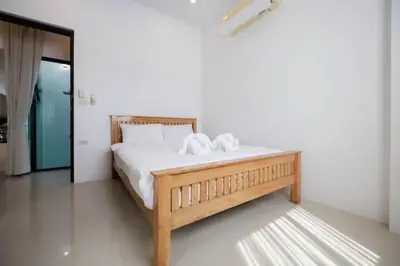 a bedroom with a bed with two towels on it at V68 Paradise Found 2BR Villa Bliss in rawai in Kata Beach
