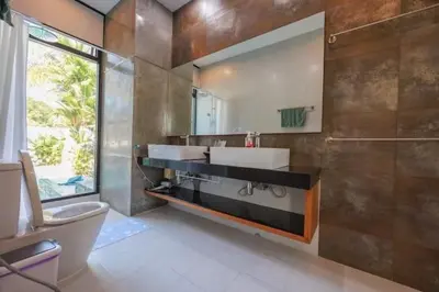 a bathroom with a sink and a toilet and a mirror at V68 Paradise Found 2BR Villa Bliss in rawai in Kata Beach