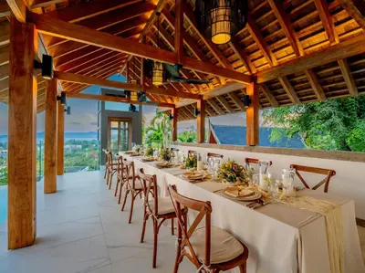 a long dining room with a long table and chairs at Baan View Talay - Sea View Zenith Villa By Elite Havens in Surin Beach