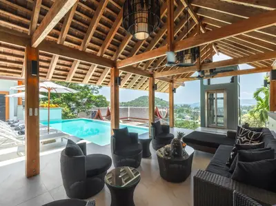 an indoor living room with a pool and furniture at Baan View Talay - Sea View Zenith Villa By Elite Havens in Surin Beach