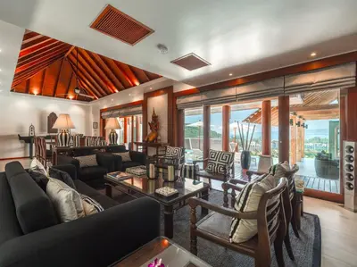 a living room with a lot of furniture and windows at Baan View Talay - Sea View Zenith Villa By Elite Havens in Surin Beach