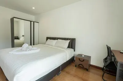 a bedroom with a large white bed with a mirror at V69 15min Convenient to Patong Building Gym in Kamala Beach