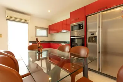 a kitchen with a glass table and a stainless steel refrigerator at V69 15min Convenient to Patong Building Gym in Kamala Beach
