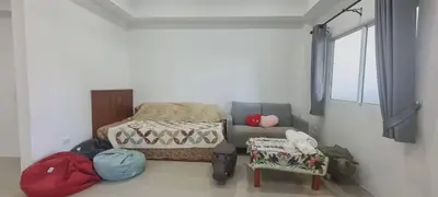 a bedroom with a bed and a couch and a window at Cosy Home in Koh Kaew in Ban Bang Khu
