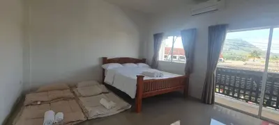 a bedroom with two beds and a large window at Cosy Home in Koh Kaew in Ban Bang Khu