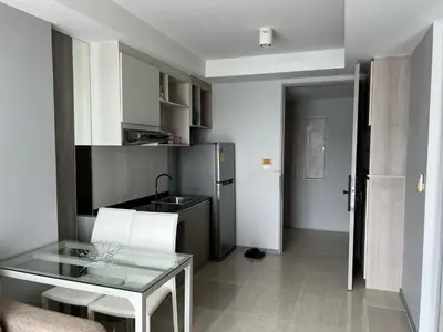 a kitchen with a glass table and a refrigerator at Condo Surin-Bangtao Beach in Surin Beach