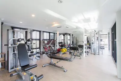 a gym with several treadmills and machines in it at Condo Surin-Bangtao Beach in Surin Beach