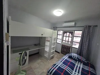 a small bedroom with a bunk bed and a window at Diamond Home in Phuket in Ban Rangeng