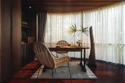 a dining room with a table and two chairs at Keemala in Kamala Beach